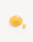A dollop of a yellow serum to showcase texture of Mwani Zanzibar’s Facial Cleanser & Mask.
