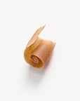 A piece of sepia colored soap, shaved from a bar.
