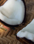 Close up view of a sliced open coconut.