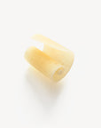 A piece of creme colored soap, shaved from a bar.