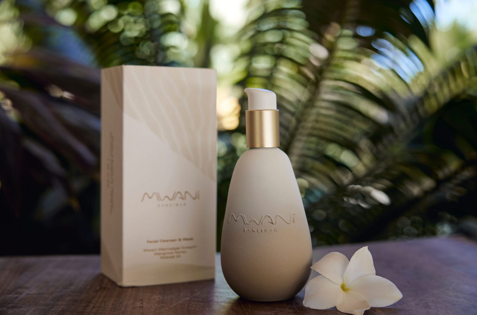 A Mwani Zanzibar bottle and protective packaging seen in the foreground, with trees in the background.