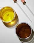 Aerial view of two oils in glass vessels.