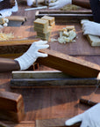 View of Mwani Zanzibar Mamas crafting soap bars at table.